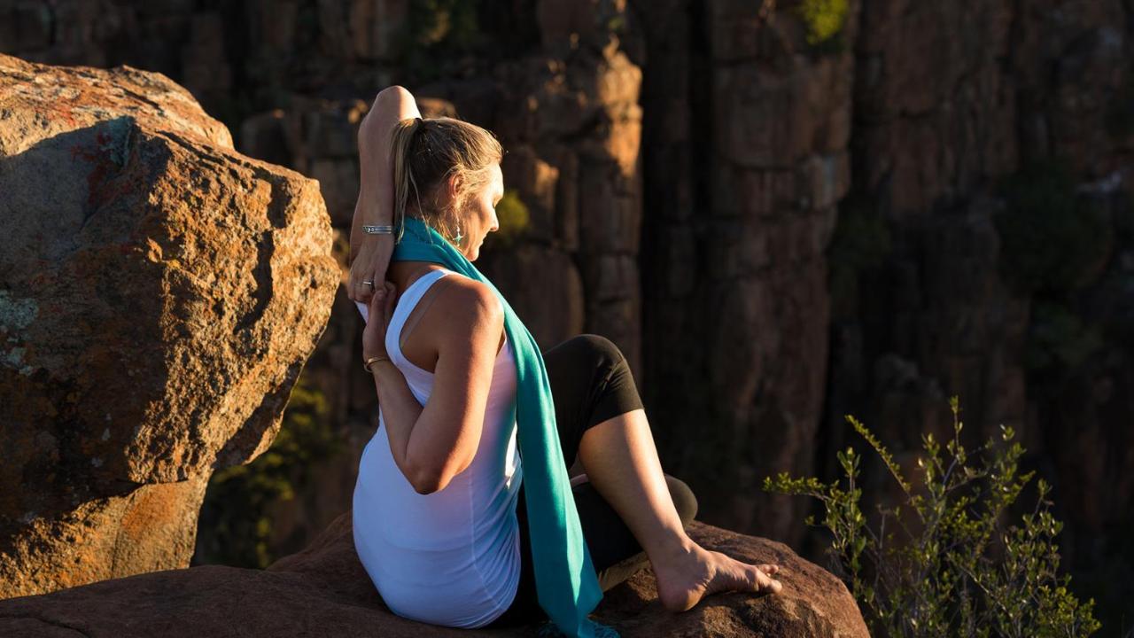Drostdy Hotel Graaff-Reinet Exteriör bild A woman practicing yoga